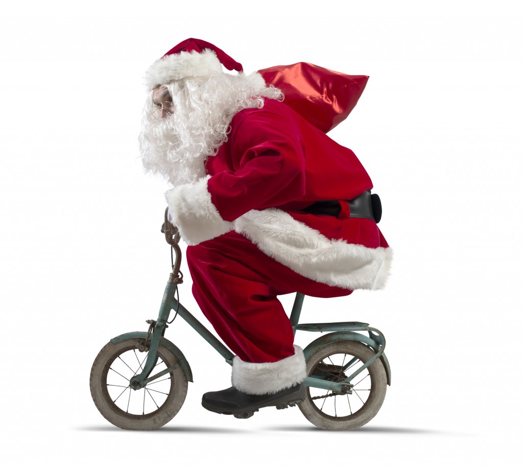 Santa claus on the bike on white background